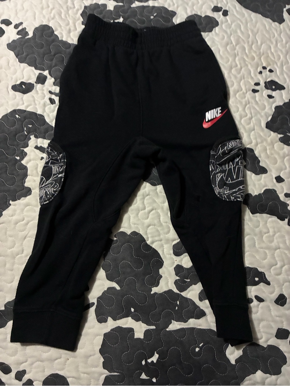 Nike Black Kids Joggers with Red Swoosh and Printed Knee Patches